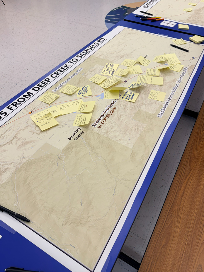 A table map of the US-95 corridor north of Sandpoint with post it notes stuck to it containing comments from meeting attendees.
