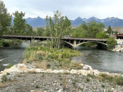 US-93 bridge over the Salmon River facing north with mountain backdrop in Salmon, Idaho.