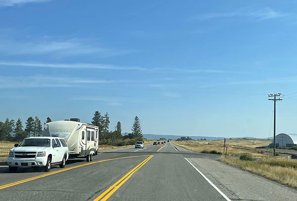 US-20 traffic and roadway between Ashton and Chester, facing north with an at-grade intersection also in the view.