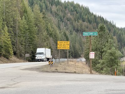 A semi truck driving through the intersection of US-95 and Deep Creek Road.