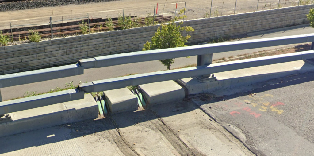 Guardrail that has separated as sections of the roadway and support walls have settled over time. 