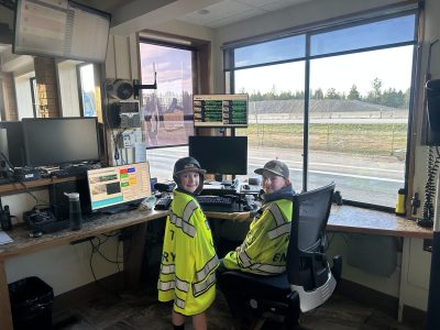 Two young boys with yellow vests sit inside the POE and smile at the camera.
