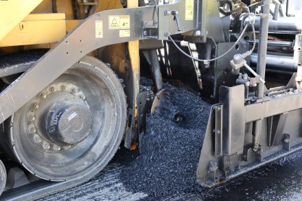 Fresh asphalt is placed during a pavement preservation project to improve roadway conditions and extend the life of the highway.