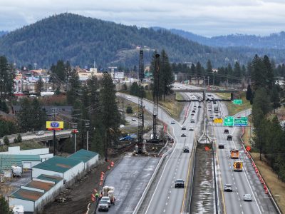 A divided four lane interstate highway with on and off ramps.