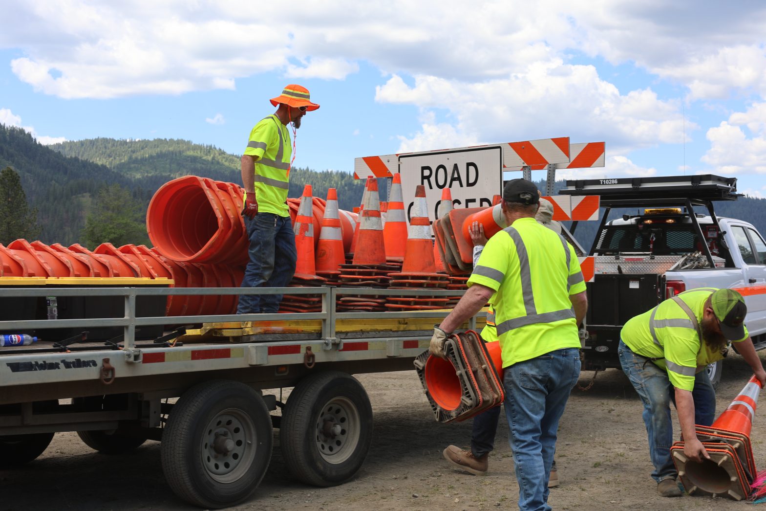 Idaho Transportation Department employees load traffic cones, barricades and work zone equipment onto trailers in preparation for roadway construction.