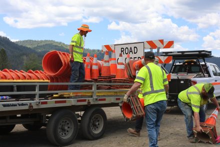 Idaho Transportation Department employees load traffic cones, barricades and work zone equipment onto trailers in preparation for roadway construction.
