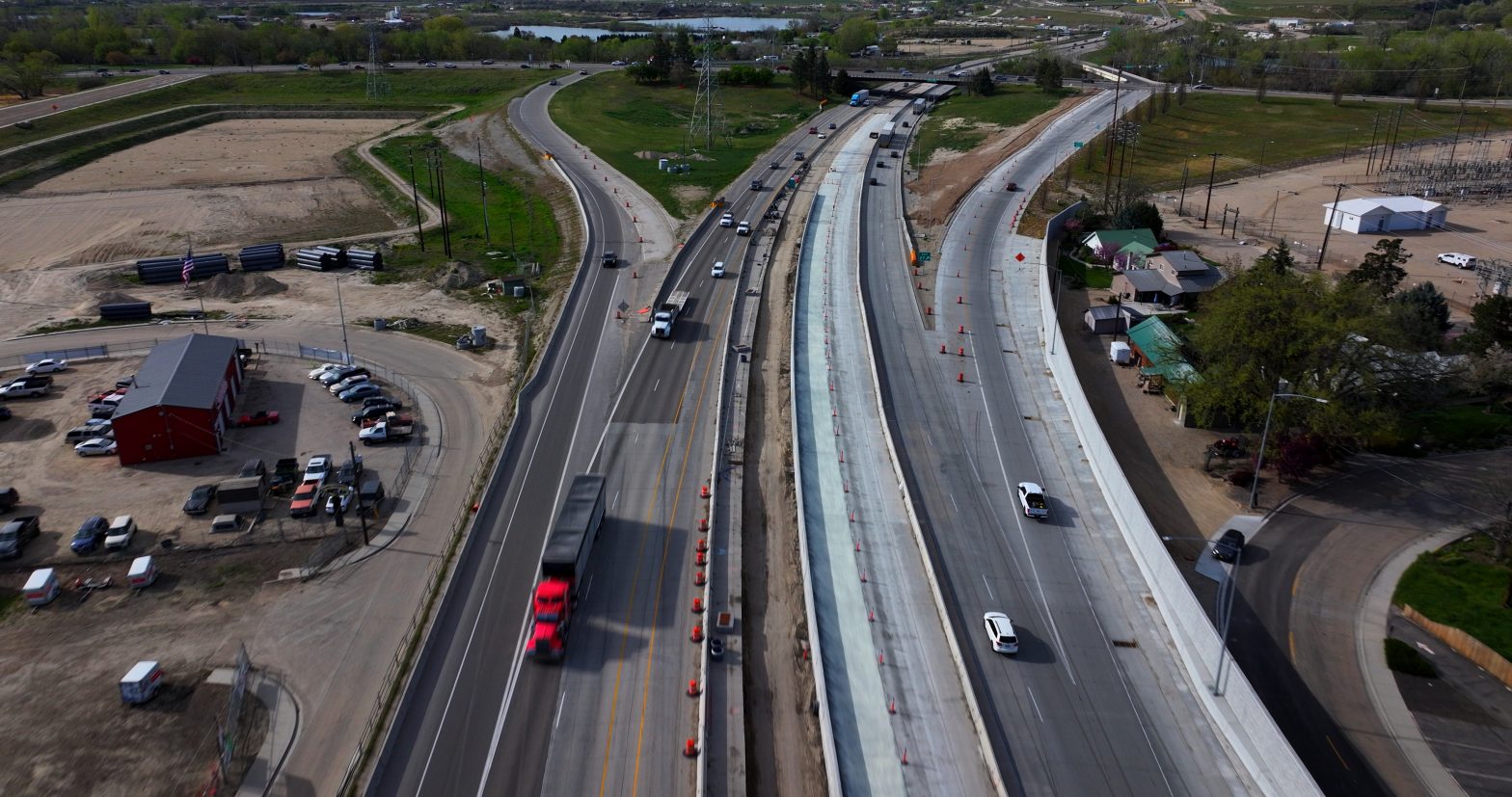 Overhead view of I-84 near the Centennial Way ramps in Caldwell, showing active construction, traffic cones, lane shifts and vehicles traveling through the work zone.