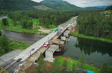 Aerial view of ongoing construction to replace an old bridge over a river