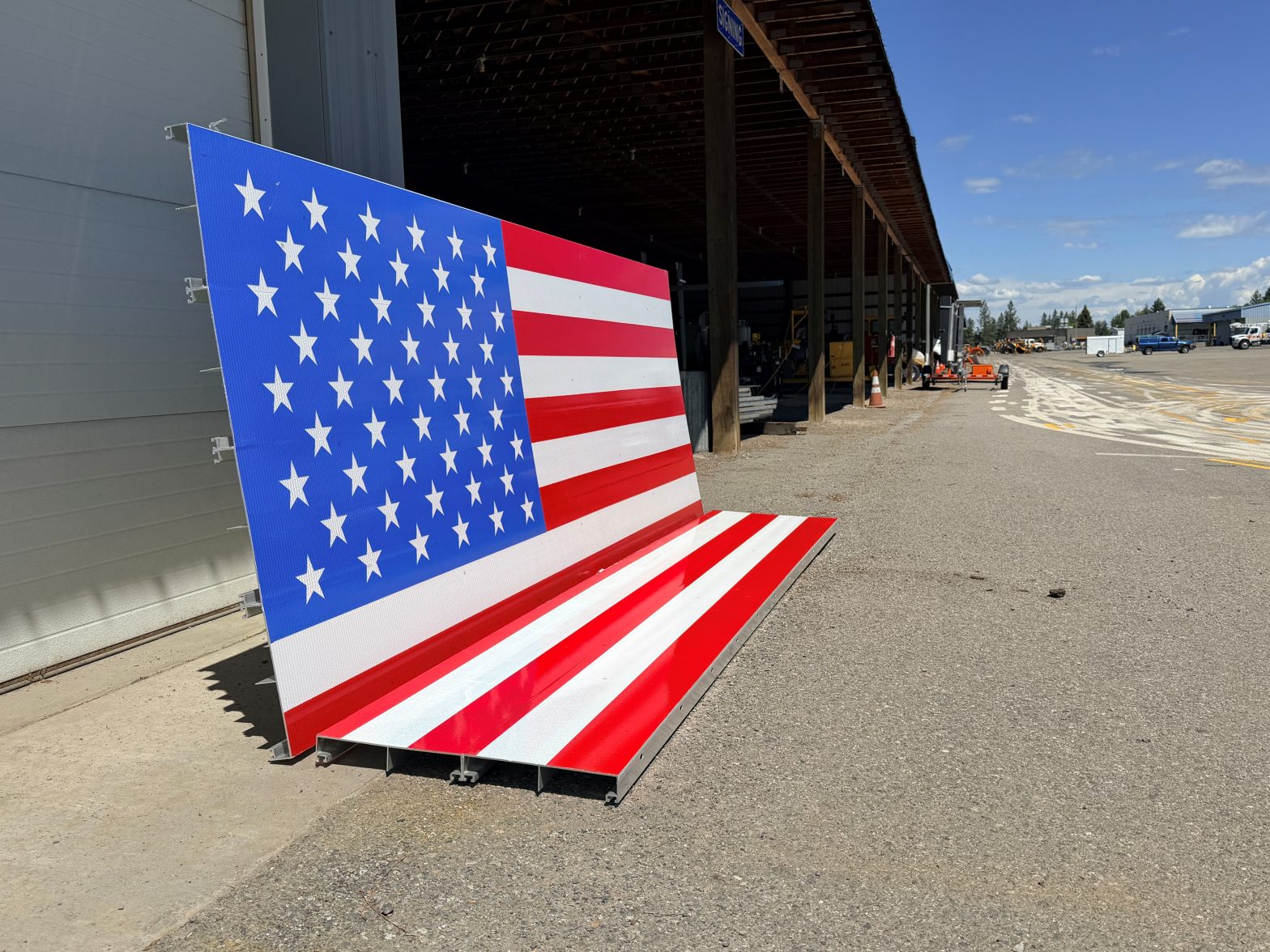 Two large pieces that make up an American flag display sign, ready for installation.