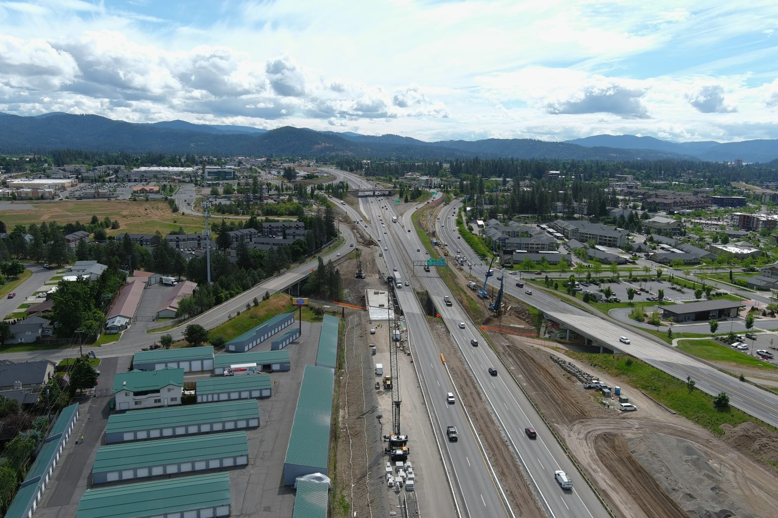 Aerial view of a busy interstate with adjacent roads and busy on-ramps