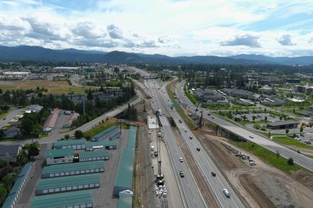 Aerial view of a busy interstate with adjacent roads and busy on-ramps