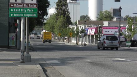 Downtown Moscow streetscape with vehicles traveling along a multi-lane roadway.