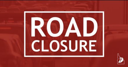Red Idaho Transportation Department graphic with large white text reading “Road Closure.”