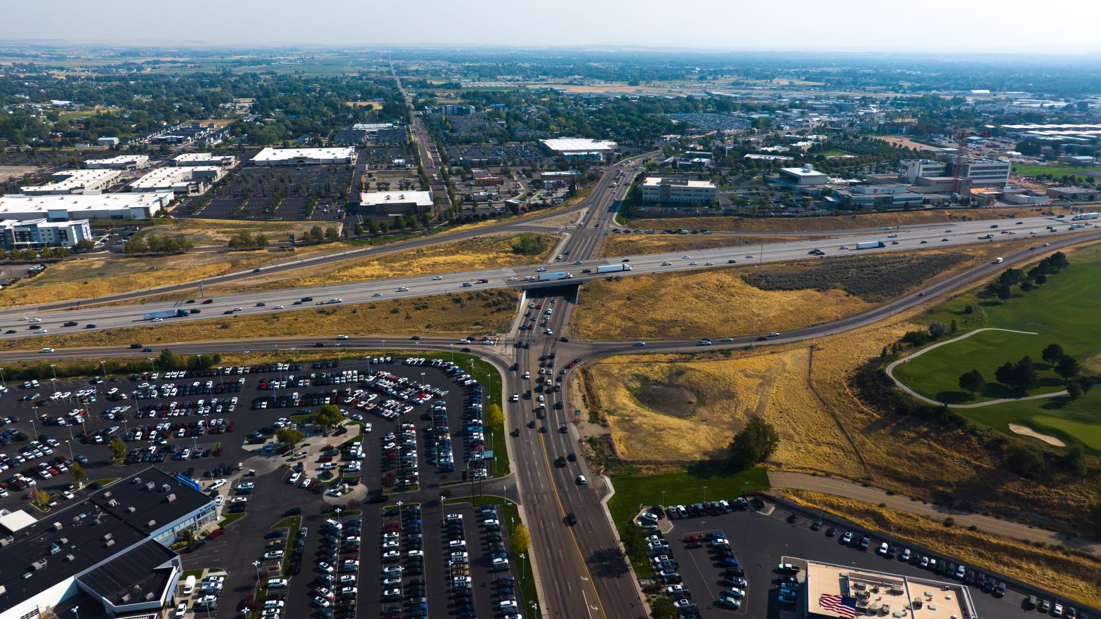 Aerial view of the Interstate 84 and Garrity Boulevard interchange in Nampa, showing highway traffic, connecting ramps and surrounding businesses.