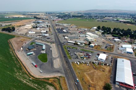 Aerial view of US-26 and Hitt Road intersection in Idaho Falls, showing the roadway, traffic and horizon to the northeast.