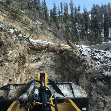 Rock and dirt from landslides had to be loaded into dump trucks and hauled off. This slide had an estimated 400 cubic yards carried away.