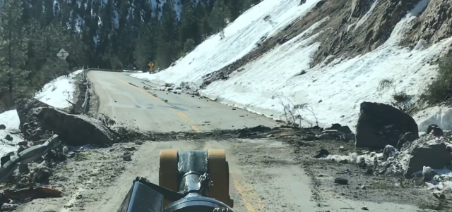 A large boulder fell and dragged across the highway, gouging the pavement. A large boulder fell and dragged across the highway, gouging the pavement.