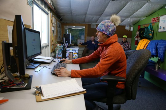 Chantel tabulates and tracks snowpack and weather data to forecast avalanche risk Woman at desk and computer